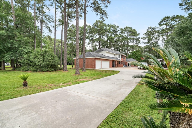 exterior space with driveway, brick siding, a front lawn, and a garage