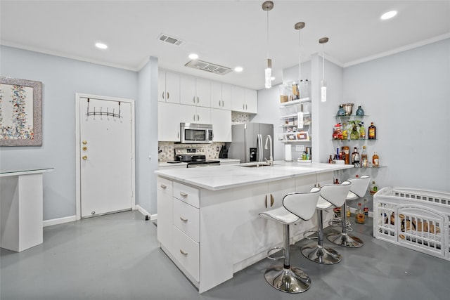9850 Pagewood Ln Unit 1302, Houston, TX 77042 - kitchen with ornamental molding, a peninsula, concrete floors, decorative backsplash, and stainless steel appliances