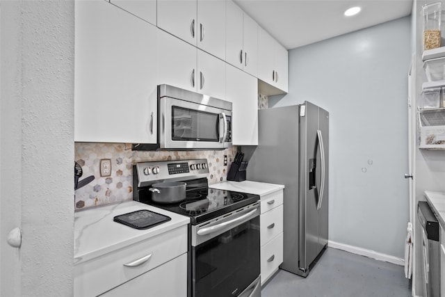 9850 Pagewood Ln Unit 1302, Houston, TX 77042 - kitchen with white cabinetry, finished concrete flooring, decorative backsplash, baseboards, and appliances with stainless steel finishes