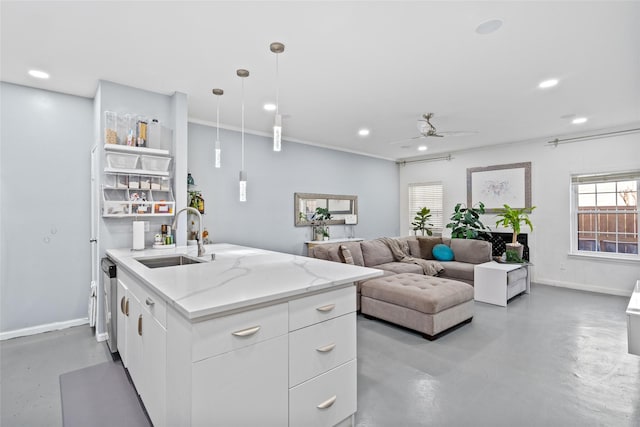 9850 Pagewood Ln Unit 1302, Houston, TX 77042 - kitchen featuring a sink, concrete flooring, a ceiling fan, white cabinets, and baseboards