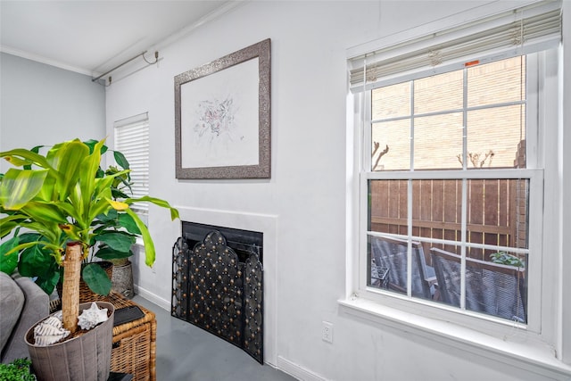 9850 Pagewood Ln Unit 1302, Houston, TX 77042 - details featuring baseboards, ornamental molding, a fireplace, and finished concrete flooring