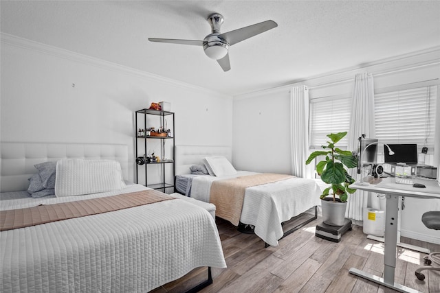 9850 Pagewood Ln Unit 1302, Houston, TX 77042 - bedroom with crown molding, a ceiling fan, and wood finished floors