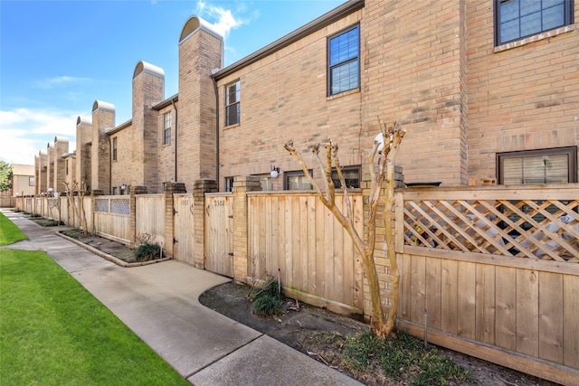9850 Pagewood Ln Unit 1302, Houston, TX 77042 - view of side of property featuring brick siding and fence