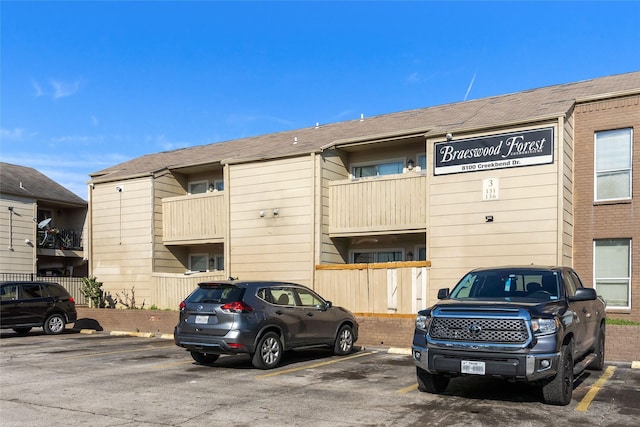 view of building exterior with uncovered parking