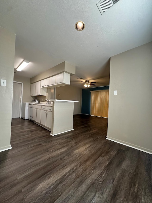 kitchen featuring ceiling fan, visible vents, open floor plan, white cabinets, and dark wood-style floors