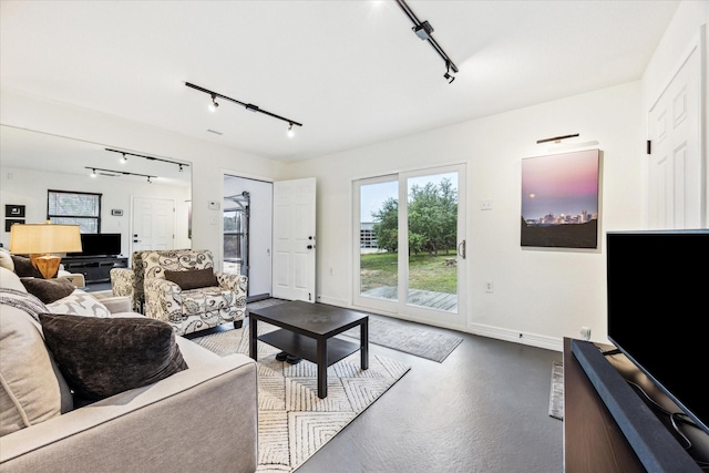1210 Persimmon Pass, Fischer, TX 78623 - living room with rail lighting, baseboards, and concrete flooring