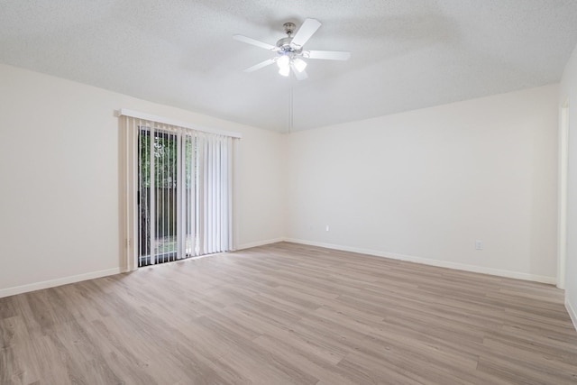 34 Quiet Peace Pl, The Woodlands, TX 77381 - spare room featuring light wood-style floors, a textured ceiling, a ceiling fan, baseboards, and vaulted ceiling