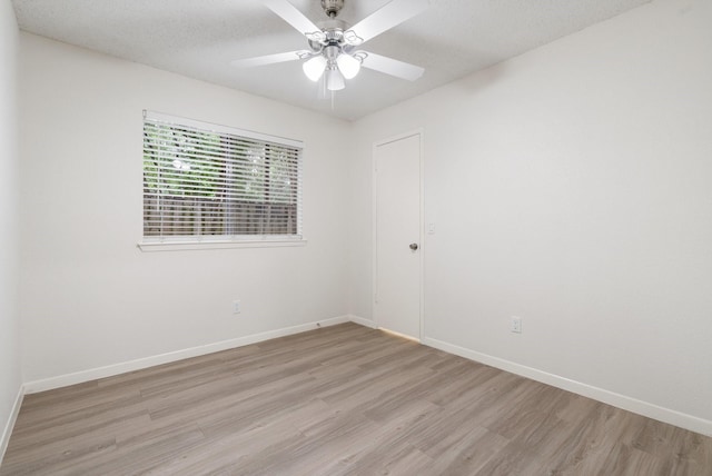 34 Quiet Peace Pl, The Woodlands, TX 77381 - unfurnished room with light wood-style floors, baseboards, and ceiling fan