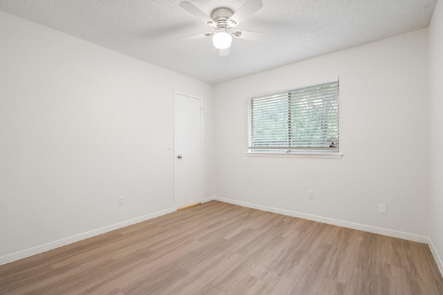 34 Quiet Peace Pl, The Woodlands, TX 77381 - unfurnished room with light wood finished floors, a ceiling fan, baseboards, and a textured ceiling