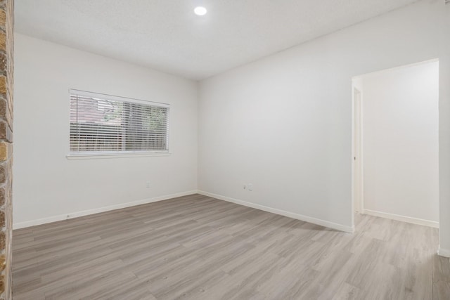 34 Quiet Peace Pl, The Woodlands, TX 77381 - empty room featuring light wood-type flooring, baseboards, and recessed lighting