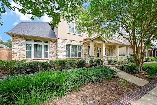 707 Weldon Park Dr, Sugar Land, TX 77479 - craftsman-style house featuring stone siding, stucco siding, covered porch, and roof with shingles