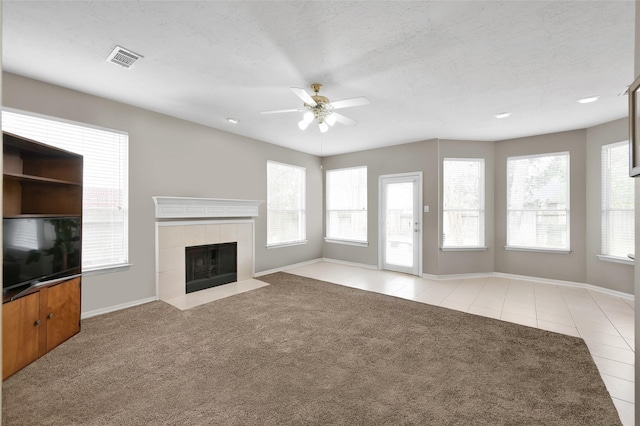 22 Almond Branch Pl, The Woodlands, TX 77382 - unfurnished living room with ceiling fan, healthy amount of natural light, baseboards, and a fireplace