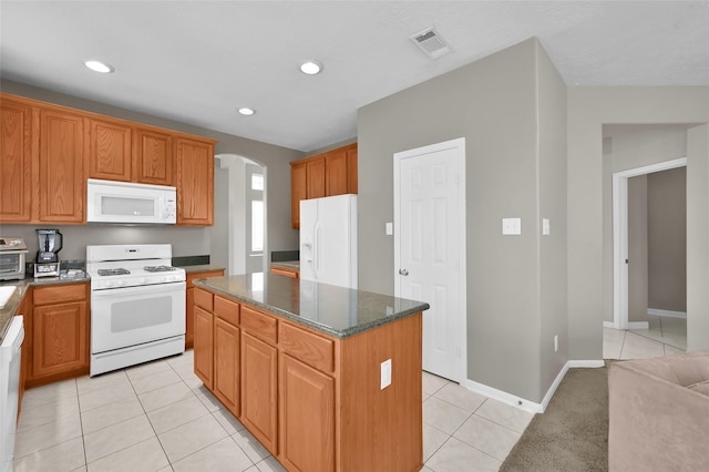 22 Almond Branch Pl, The Woodlands, TX 77382 - kitchen with white appliances, arched walkways, a kitchen island, light tile patterned floors, and recessed lighting
