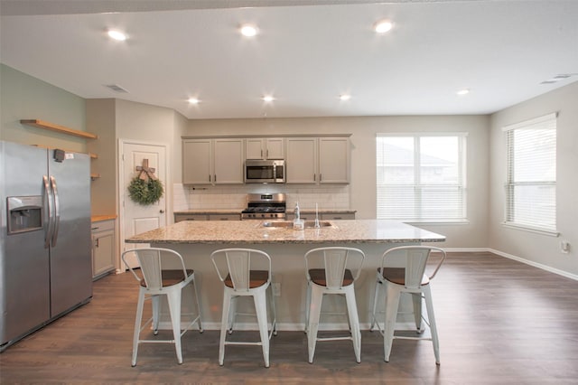 16129 Barge Way, Crosby, TX 77532 - kitchen with stainless steel appliances, a sink, open shelves, decorative backsplash, and dark wood-type flooring