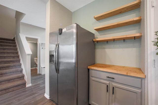 16129 Barge Way, Crosby, TX 77532 - kitchen with stainless steel fridge with ice dispenser, butcher block countertops, dark wood-style floors, gray cabinetry, and baseboards