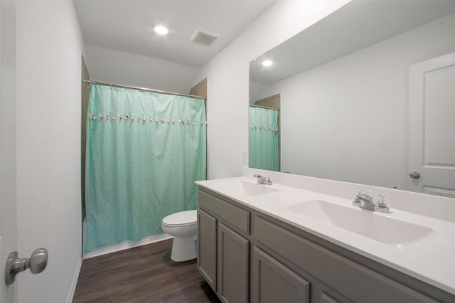 16129 Barge Way, Crosby, TX 77532 - bathroom with wood finished floors, toilet, double vanity, and shower / bath combo