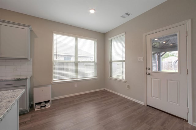 16129 Barge Way, Crosby, TX 77532 - unfurnished dining area with plenty of natural light and wood finished floors