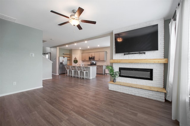 16129 Barge Way, Crosby, TX 77532 - unfurnished living room with ceiling fan, baseboards, dark wood-style flooring, and a brick fireplace