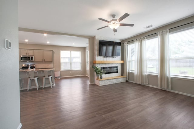 16129 Barge Way, Crosby, TX 77532 - living room with a ceiling fan, dark wood-type flooring, baseboards, a brick fireplace, and recessed lighting