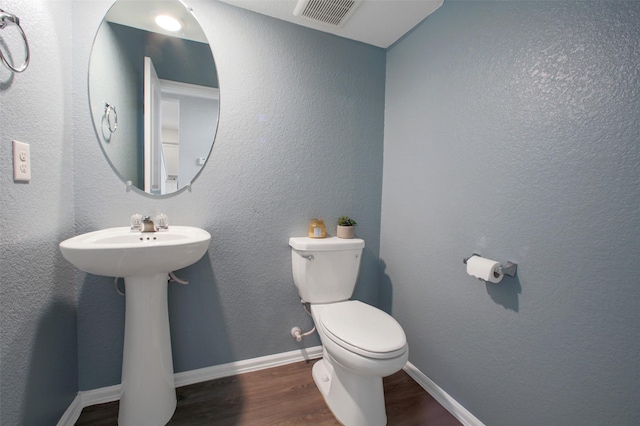 16129 Barge Way, Crosby, TX 77532 - bathroom featuring wood finished floors, toilet, and baseboards