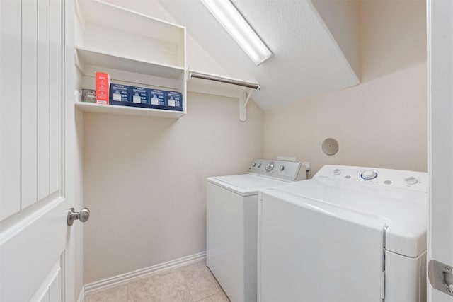laundry area with separate washer and dryer and baseboards