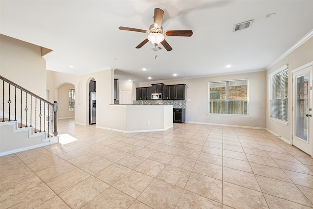 unfurnished living room featuring light tile patterned floors, ornamental molding, a ceiling fan, arched walkways, and recessed lighting