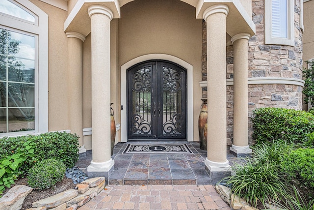 2802 Twin Fountains Dr, Houston, TX 77068 - doorway to property with stucco siding and stone siding