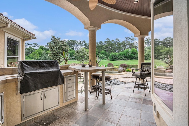 2802 Twin Fountains Dr, Houston, TX 77068 - view of patio featuring an outdoor kitchen, ceiling fan, area for grilling, and view of scattered trees