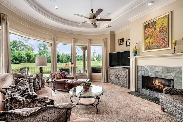 2802 Twin Fountains Dr, Houston, TX 77068 - tiled living room with ornamental molding, a tray ceiling, ceiling fan, plenty of natural light, and a fireplace