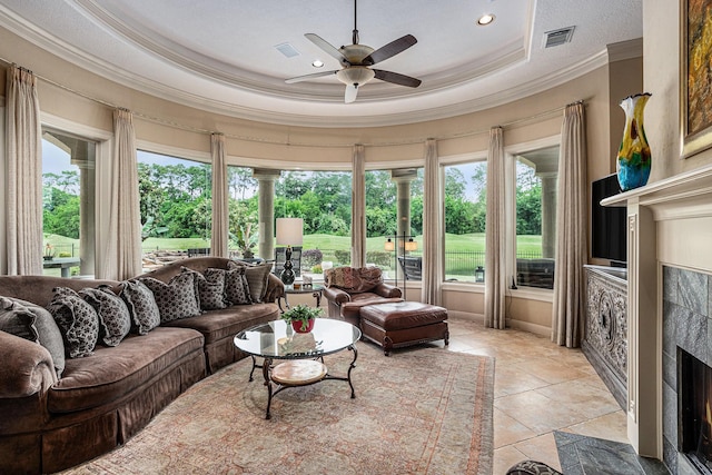 2802 Twin Fountains Dr, Houston, TX 77068 - living room featuring ornamental molding, ceiling fan, a high end fireplace, a tray ceiling, and recessed lighting