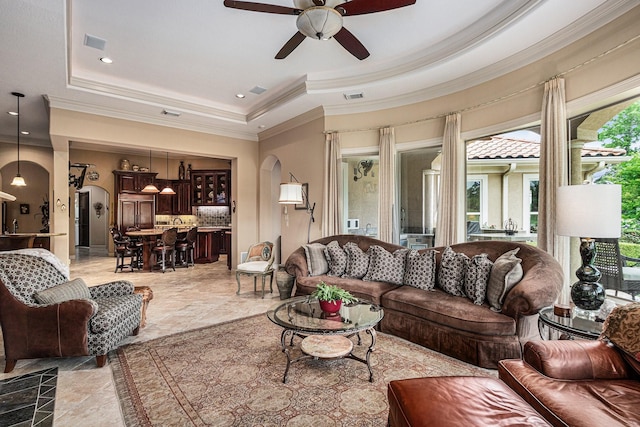 2802 Twin Fountains Dr, Houston, TX 77068 - living room featuring a raised ceiling, a ceiling fan, ornamental molding, and arched walkways