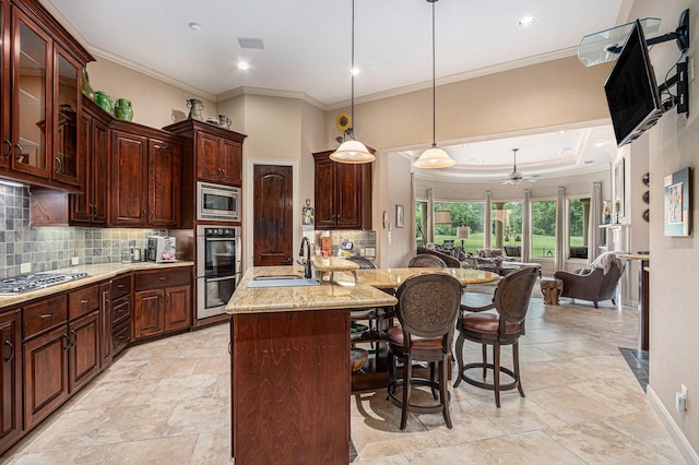 2802 Twin Fountains Dr, Houston, TX 77068 - kitchen with a sink, appliances with stainless steel finishes, open floor plan, a breakfast bar area, and backsplash