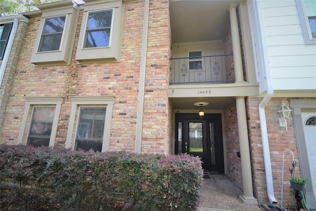 14459 Misty Meadow Ln, Houston, TX 77079 - doorway to property with brick siding and a balcony