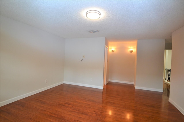 14459 Misty Meadow Ln, Houston, TX 77079 - spare room with wood finished floors, a textured ceiling, and baseboards
