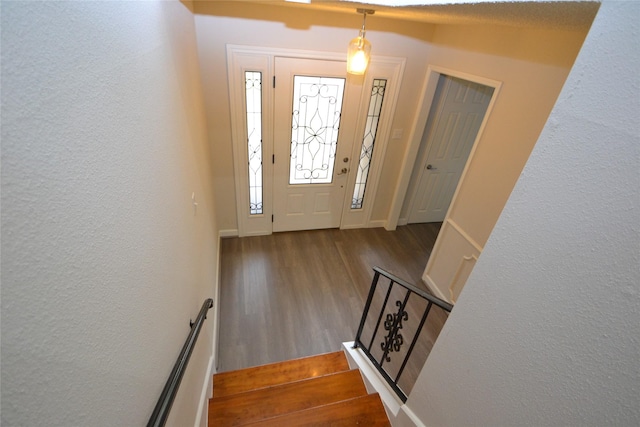 14459 Misty Meadow Ln, Houston, TX 77079 - foyer featuring wood finished floors, a textured wall, baseboards, and stairway