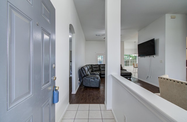 3116 Grassmere St, Houston, TX 77051 - hall with light tile patterned flooring, baseboards, and arched walkways
