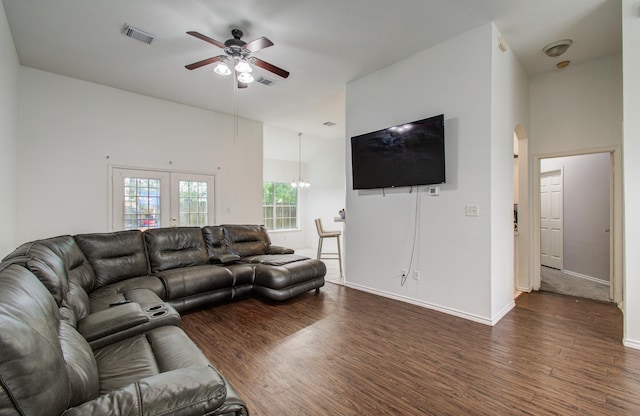 3116 Grassmere St, Houston, TX 77051 - living room featuring a ceiling fan, dark wood-style flooring, arched walkways, baseboards, and a towering ceiling