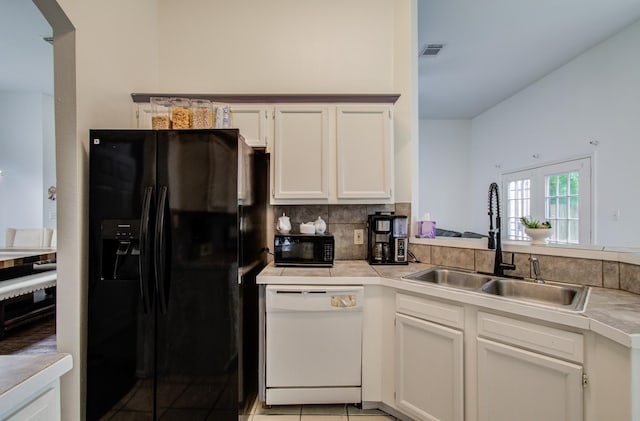 3116 Grassmere St, Houston, TX 77051 - kitchen featuring black appliances, a sink, white cabinets, and tasteful backsplash