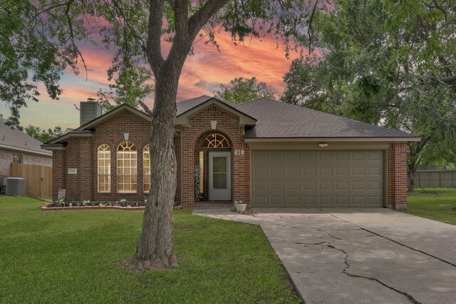 view of front facade with brick siding, central AC, concrete driveway, an attached garage, and a chimney