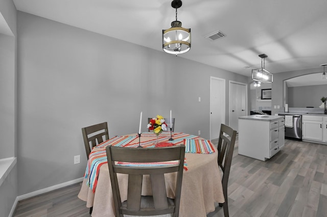 dining area with wood finished floors and baseboards