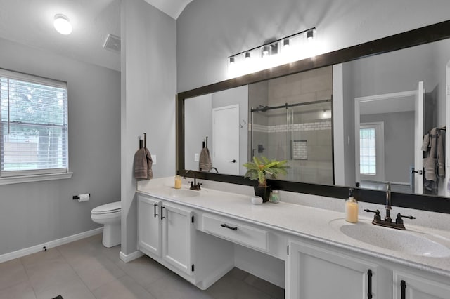 bathroom featuring a stall shower, toilet, healthy amount of natural light, and tile patterned floors