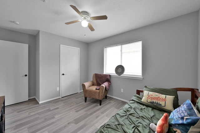 bedroom with light wood-type flooring, baseboards, and a ceiling fan