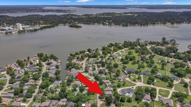 view of property location featuring a nearby body of water and nearby suburban area