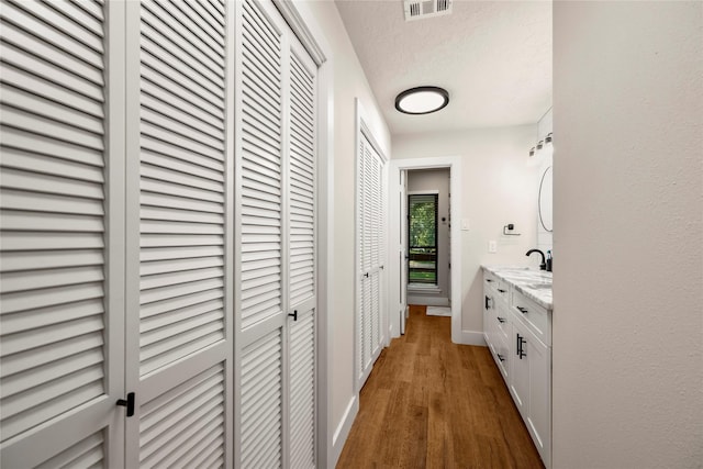 hall with wood finished floors and baseboards