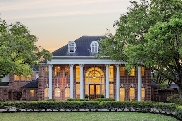 back of house with brick siding and covered porch