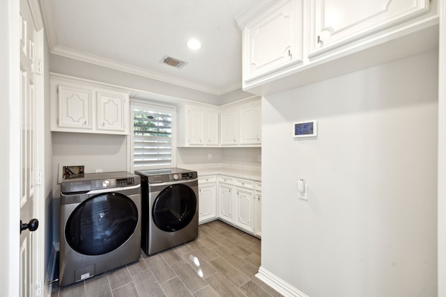 washroom featuring cabinet space, washer and clothes dryer, crown molding, wood finish floors, and recessed lighting