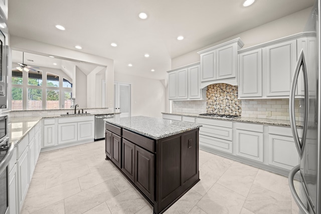 28209 Regal Wood Ct, Spring, TX 77386 - kitchen with stainless steel appliances, recessed lighting, backsplash, a ceiling fan, and a sink
