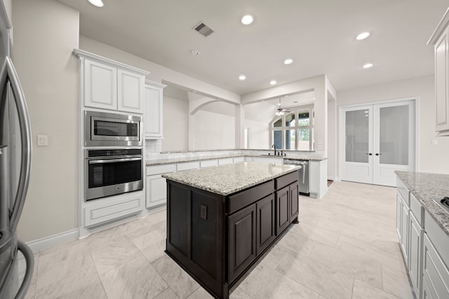 28209 Regal Wood Ct, Spring, TX 77386 - kitchen featuring stainless steel appliances, french doors, white cabinets, a ceiling fan, and recessed lighting