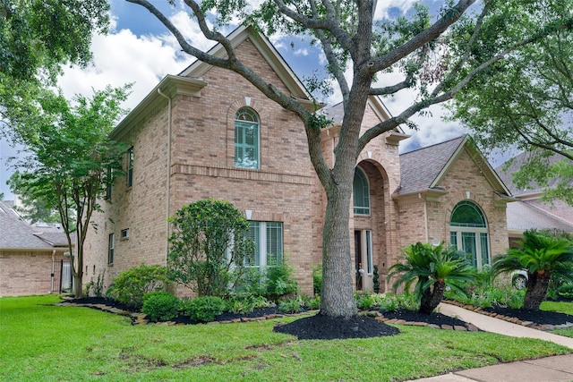 2130 White Eagle Ln, Katy, TX 77450 - traditional home with brick siding and a front lawn