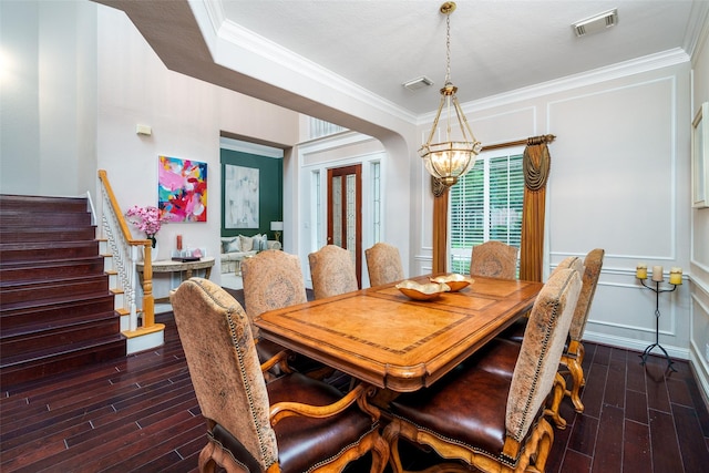 2130 White Eagle Ln, Katy, TX 77450 - dining space featuring a chandelier, wood finished floors, crown molding, and stairway